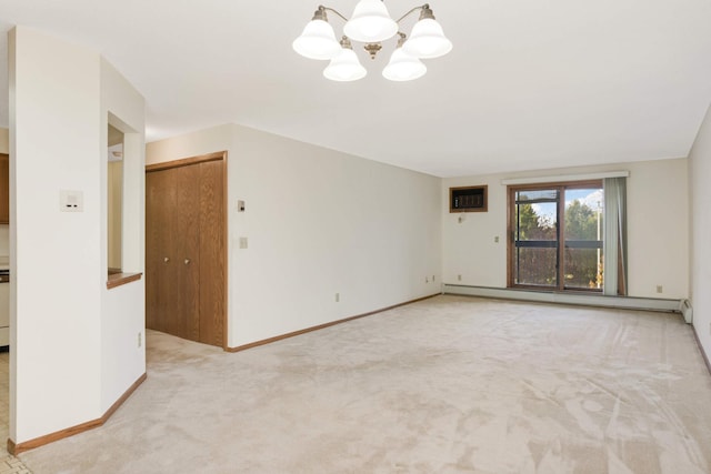 carpeted spare room with a baseboard heating unit, a wall unit AC, and a chandelier