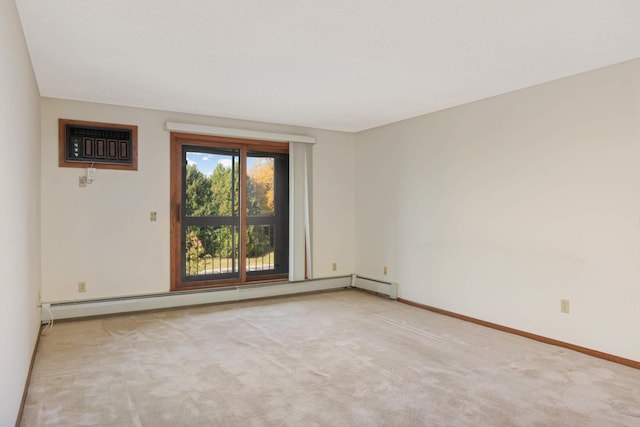 spare room with a wall unit AC, light colored carpet, and baseboard heating