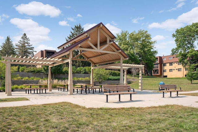 surrounding community featuring a pergola and a yard