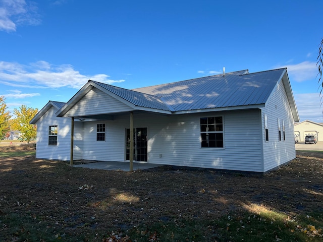 back of property with a patio