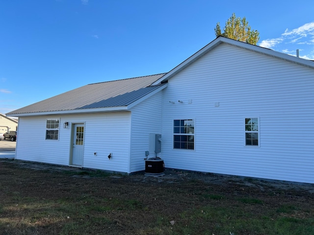 rear view of property featuring central air condition unit