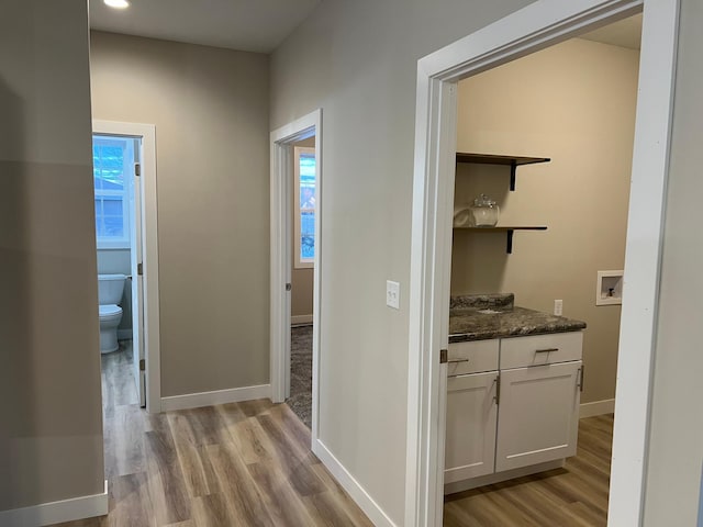 corridor with light hardwood / wood-style floors