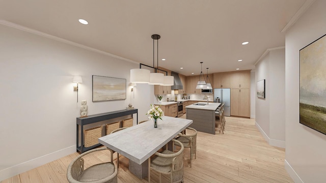 dining area with ornamental molding, sink, and light wood-type flooring