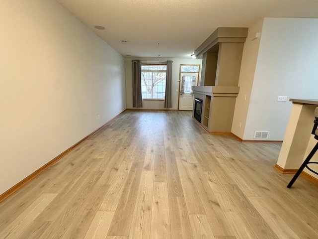 unfurnished living room featuring light hardwood / wood-style floors