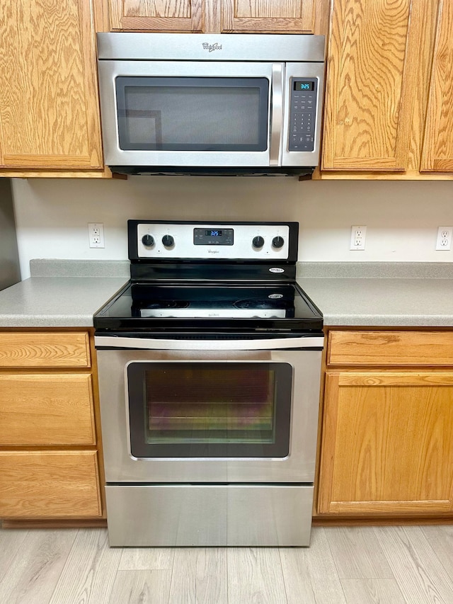 kitchen featuring stainless steel appliances and light wood-type flooring