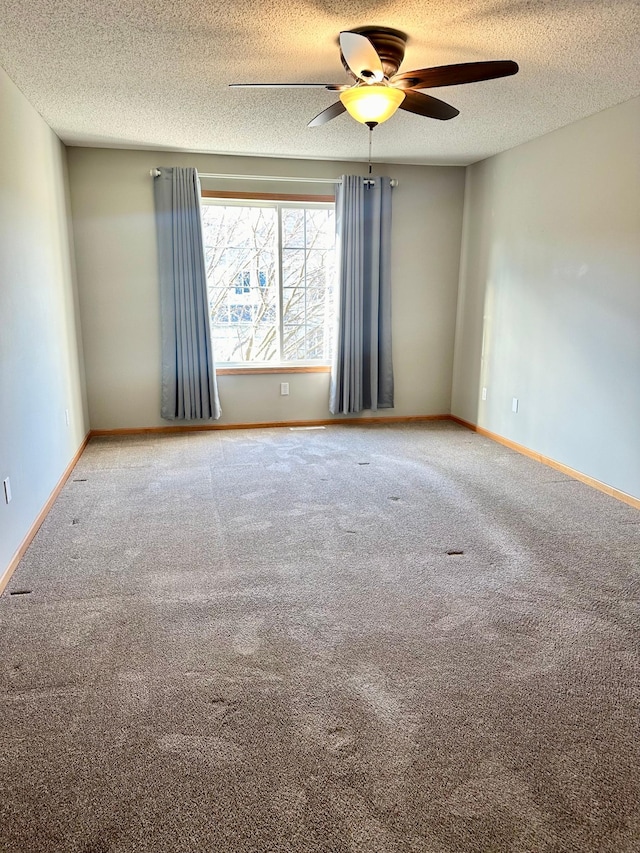 unfurnished room with carpet flooring, ceiling fan, and a textured ceiling