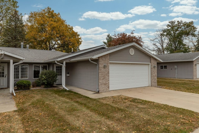 ranch-style home with a garage and a front lawn