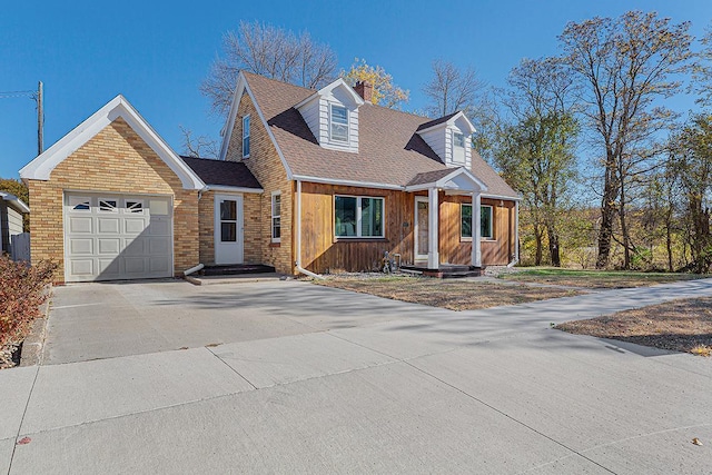 cape cod home featuring a garage