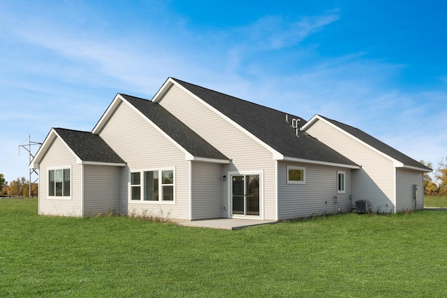 rear view of property featuring a yard and central AC