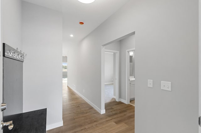 hallway with hardwood / wood-style floors