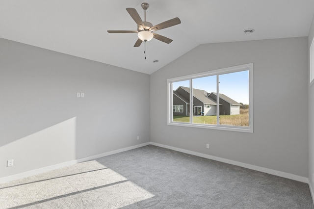 carpeted spare room with lofted ceiling and ceiling fan