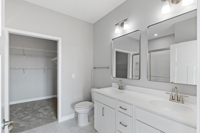 bathroom with vanity, toilet, and a shower with door