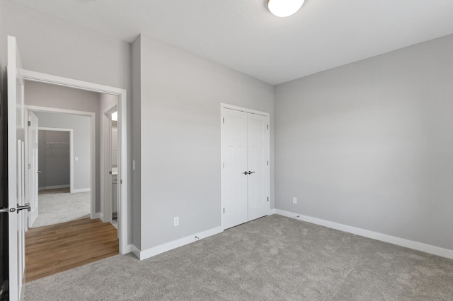 unfurnished bedroom featuring a closet and carpet flooring