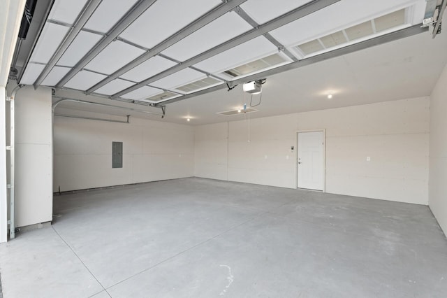 garage with a garage door opener and electric panel