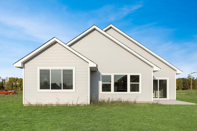 rear view of property with a patio area and a lawn