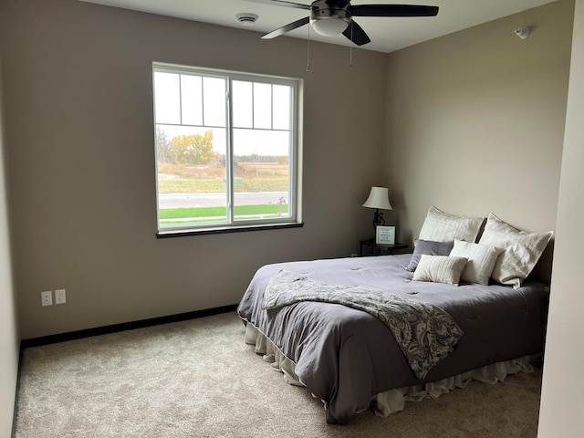 bedroom with ceiling fan and light carpet