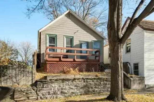 rear view of house featuring a wooden deck