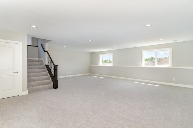 basement featuring light colored carpet