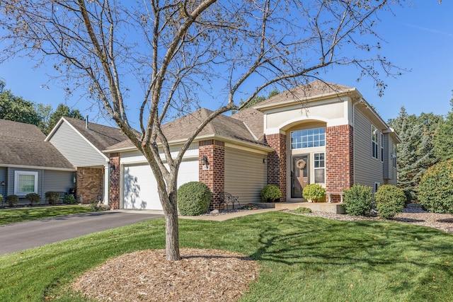 view of front of property featuring a garage and a front lawn