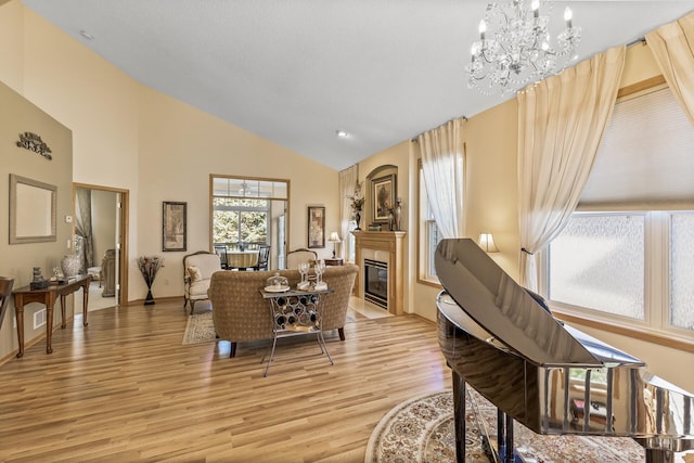 interior space with a chandelier, light hardwood / wood-style floors, and high vaulted ceiling