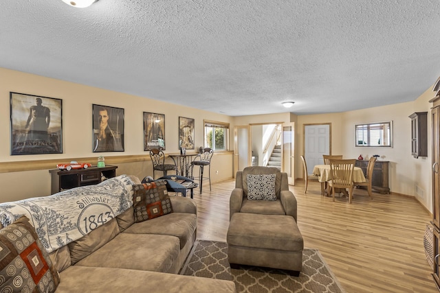 living room with hardwood / wood-style flooring and a textured ceiling