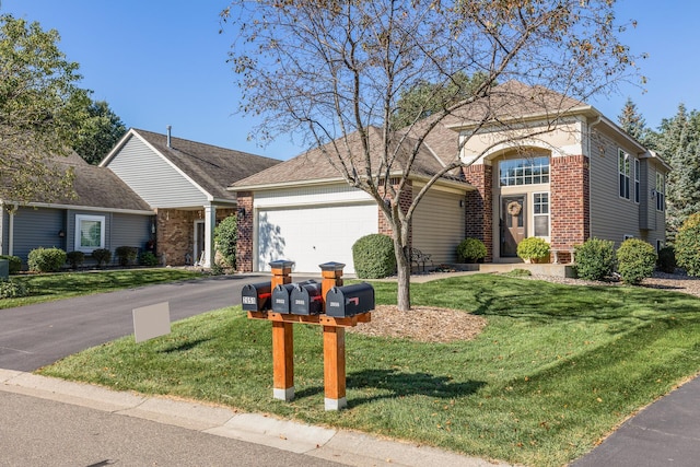 view of front of house with a garage and a front yard