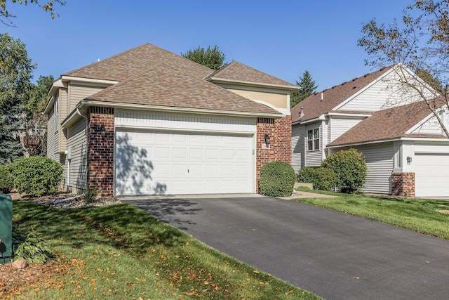 front facade with a garage and a front lawn