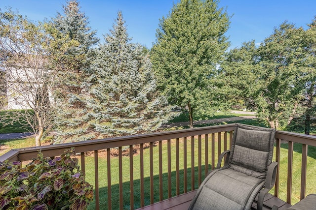 wooden terrace featuring a yard