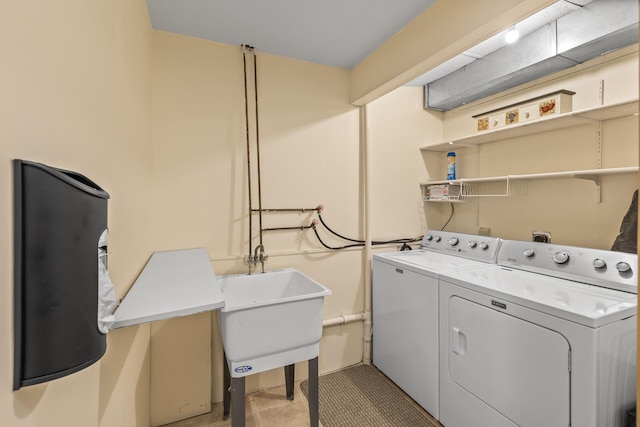 washroom with separate washer and dryer and sink