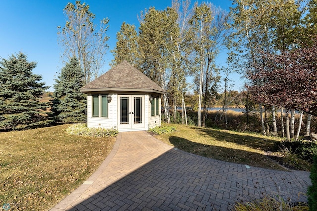 exterior space featuring a lawn and french doors