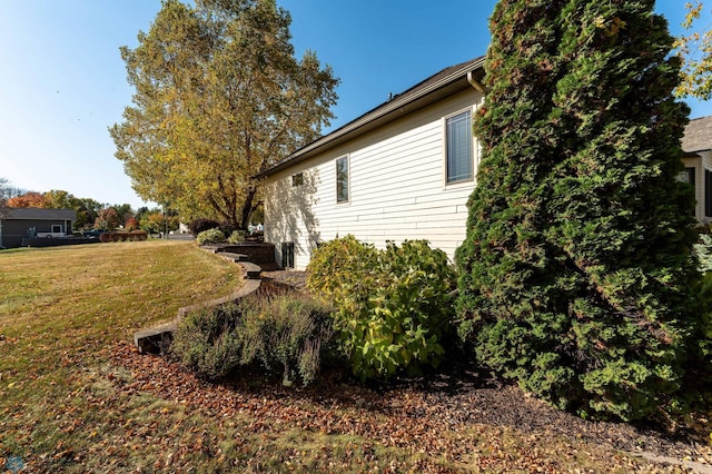 view of side of home featuring a lawn