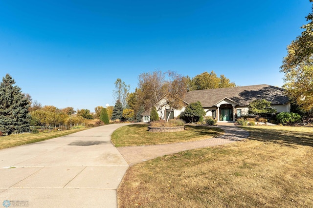 ranch-style home featuring a front yard