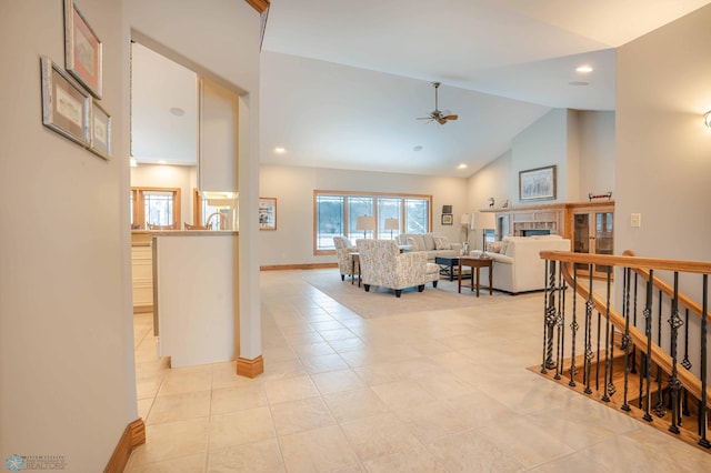 living room with ceiling fan, light tile patterned floors, and high vaulted ceiling