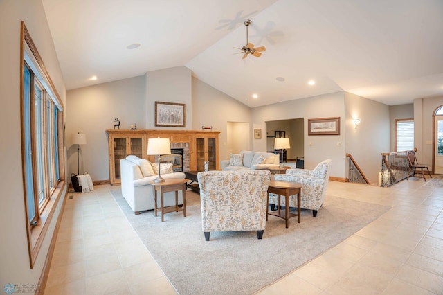 tiled living room featuring ceiling fan and lofted ceiling