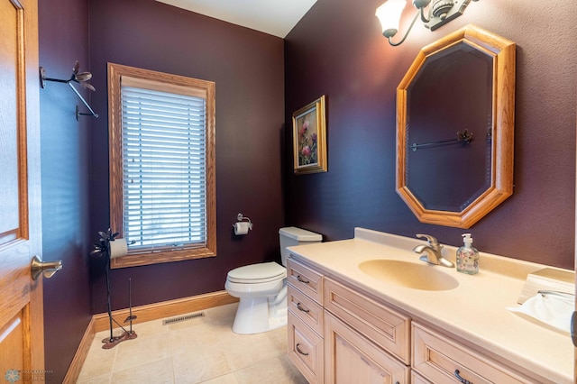 bathroom with tile patterned floors, vanity, and toilet