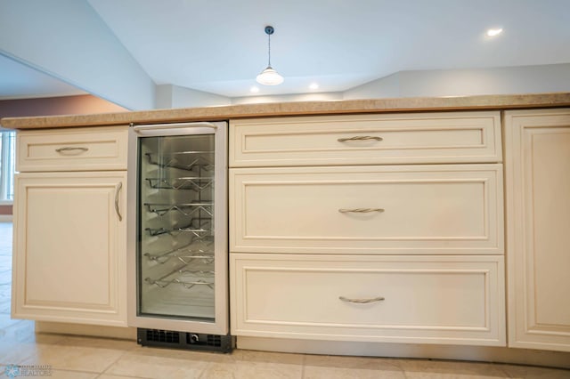 room details with pendant lighting, wine cooler, and cream cabinets