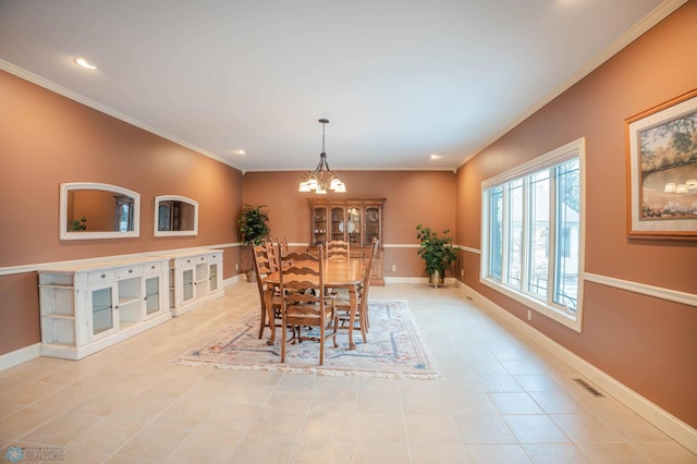 tiled dining area with a chandelier and crown molding