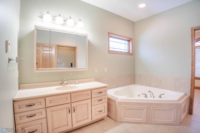 bathroom with tile patterned flooring, vanity, and a bathing tub