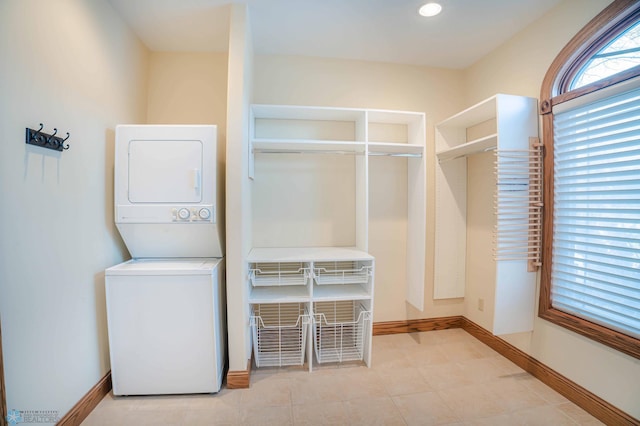 laundry room featuring stacked washer / drying machine