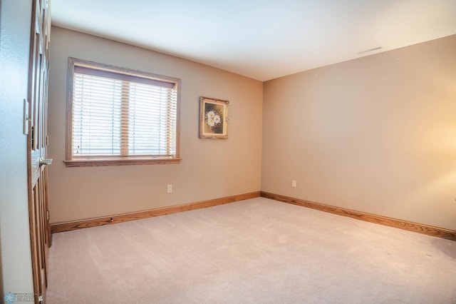 empty room featuring light colored carpet