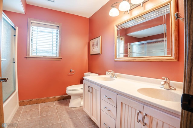 full bathroom featuring shower / bath combination with glass door, tile patterned flooring, vanity, and toilet