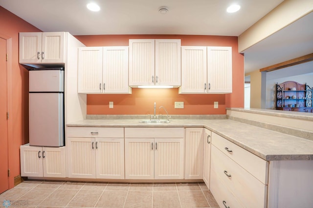 kitchen with sink and white fridge