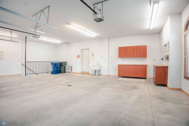 garage featuring sink and a garage door opener