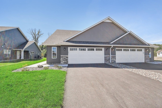 craftsman house with a garage and a front yard