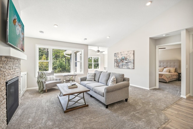 living room featuring wood-type flooring, vaulted ceiling, and ceiling fan