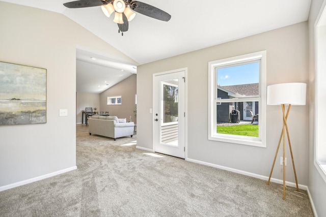 unfurnished room featuring ceiling fan, vaulted ceiling, and light carpet