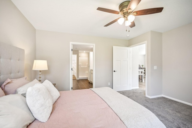 bedroom with ensuite bath, ceiling fan, and dark carpet