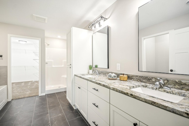 bathroom with walk in shower and vanity