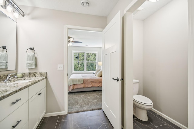 bathroom with ceiling fan, vanity, and toilet