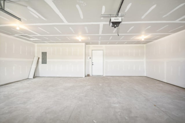 garage featuring electric panel and a garage door opener